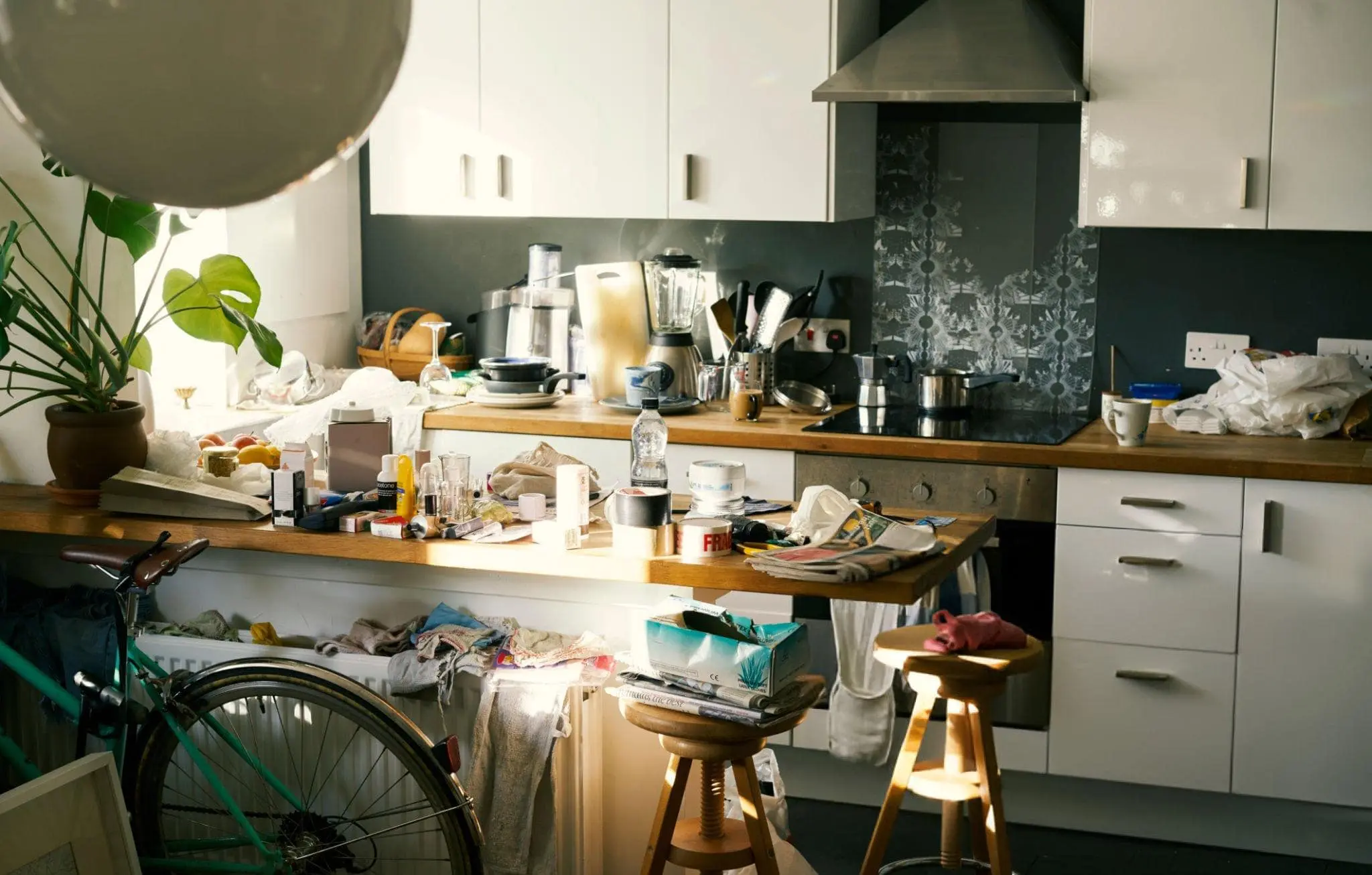 Cluttered kitchen filled with random items, symbolizing the need to let go of physical and emotional chaos.